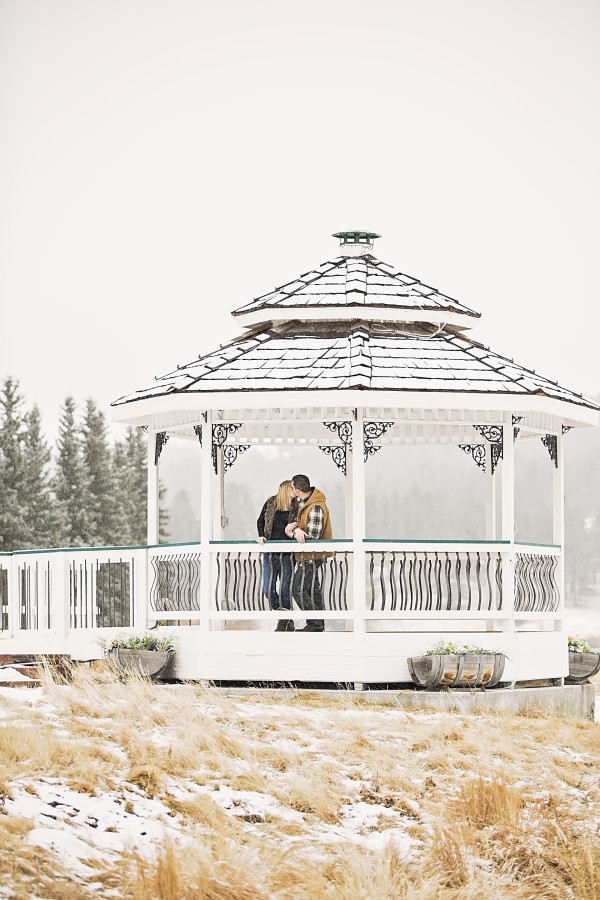 engagement-couple-kissing-in-gazebo-winter