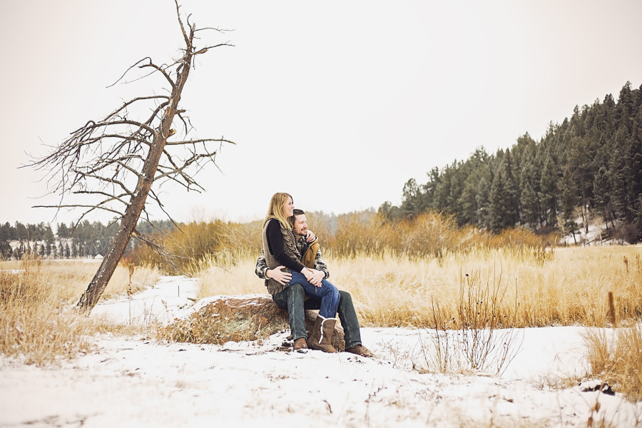 engagement-couple-tree-sitting-on-rock