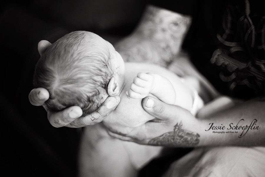 6-black-and-white-dads-hands-holding-baby