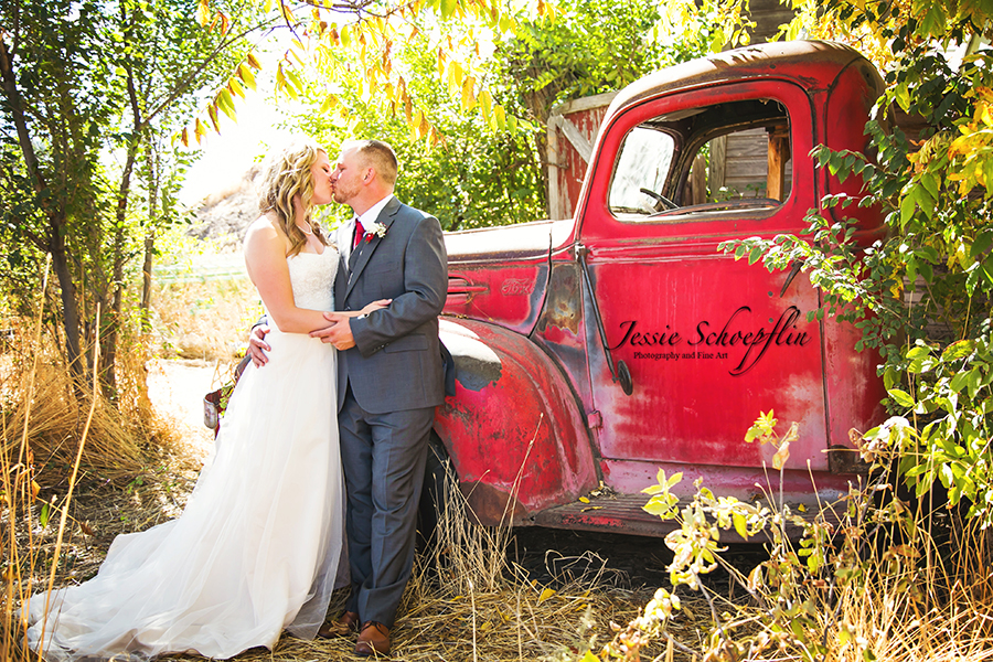 6-bride-and-groom-kissing-by-red-truck